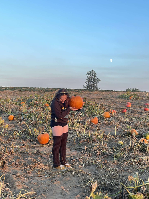 Lisa standing in a pumpkin patch